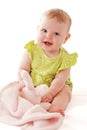 Laughing blue eyed baby plays with soft blanket Royalty Free Stock Photo