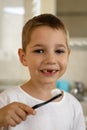 Laughing boy brushing his teeth in the bathroom. Prevention of childhood caries Royalty Free Stock Photo