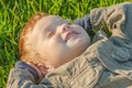 Laughing boy child lies grass. childhood person Royalty Free Stock Photo