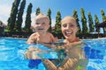 Laughing boy with joyful mother summing in the pool Royalty Free Stock Photo