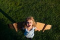 Laughing boy kid traveller with backpack wings. Child playing pilot aviator and dreams outdoors in park.