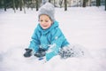 Laughing boy lying in the snow Royalty Free Stock Photo
