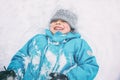 Laughing boy lying in the snow Royalty Free Stock Photo