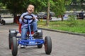 Laughing boy in a pedal cart, having fun Royalty Free Stock Photo