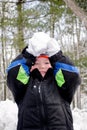 Laughing boy ready to throw a big snow ball