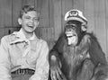 Laughing boy scout and monkey wearing hat Royalty Free Stock Photo