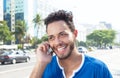 Laughing brazilian man at phone at city Royalty Free Stock Photo