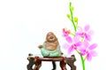 Laughing buddha figurine and pink orchid flowers Royalty Free Stock Photo