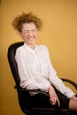 Laughing business woman sitting on the black chair Royalty Free Stock Photo