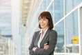Laughing business woman standing with arms crossed outside Royalty Free Stock Photo