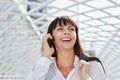 Laughing business woman talking on cellphone in station Royalty Free Stock Photo