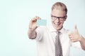 Laughing businessman giving thumbs up at blank card. Royalty Free Stock Photo