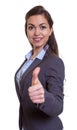 Laughing businesswoman with brown hair showing thumb up Royalty Free Stock Photo