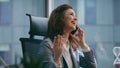 Laughing businesswoman rejoicing phone call sitting office close up. Happy girl Royalty Free Stock Photo