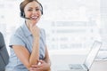 Laughing call centre agent wearing headset at her desk Royalty Free Stock Photo