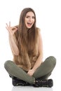 Laughing Casual Sitting Girl Showing Ok Hand Sign Royalty Free Stock Photo