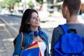 Laughing caucasian female student talking with male student in city Royalty Free Stock Photo