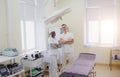 Laughing Caucasian male doctor and African American female doctor in a medical office. Royalty Free Stock Photo