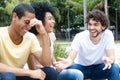 Laughing caucasian man talking with african american and latin f Royalty Free Stock Photo