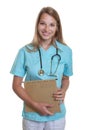 Laughing caucasian nurse with medical file