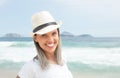 Laughing caucasian woman with hat at beach Royalty Free Stock Photo