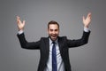 Laughing cheerful young business man in classic black suit shirt tie posing isolated on grey wall background Royalty Free Stock Photo