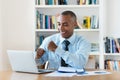 Laughing and cheering african american businessman working at computer Royalty Free Stock Photo