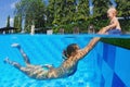 Laughing child with joyful mother swimming in the pool Royalty Free Stock Photo