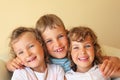 Laughing children three together in cosy room Royalty Free Stock Photo