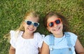 Laughing children wearing sunglasses relaxing during summer day