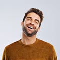 Laughing, comedy and portrait of happy man by white background. Smile, confident and face laugh of comic person Royalty Free Stock Photo