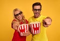 Laughing couple friends guy and girl in 3d glasses isolated on yellow. People in cinema lifestyle concept. Watching movie film