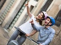 Laughing couple going sightseeing by segways