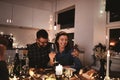 Laughing couple having fun at a dinner party with friends Royalty Free Stock Photo