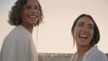 Laughing couple looking distance at sunny place closeup. Skaters walking stadium Royalty Free Stock Photo