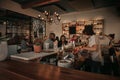 Laughing couple talking with a bartender in a pub Royalty Free Stock Photo