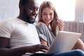 Laughing couple using laptop together Royalty Free Stock Photo