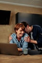 Laughing couple using a laptop together Royalty Free Stock Photo