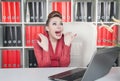 Laughing crazy business woman in office