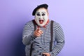 Laughing crazy plump mime points with finger at you