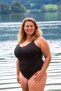 Laughing Curvy Model in swimsuit