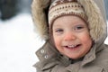 Laughing cute baby boy winter snow