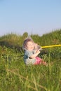 Laughing cute little boy sitting on grass Royalty Free Stock Photo