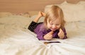 Laughing cute little girl gen Z using online app on mobile phone, browsing internet, playing video games, taking selfie Royalty Free Stock Photo