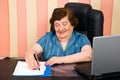 Laughing elder woman write on paper Royalty Free Stock Photo