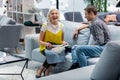 Laughing elderly lady selecting furniture upholstery with smiling handsome son