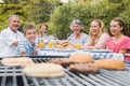 Laughing family having a barbecue in the park together Royalty Free Stock Photo