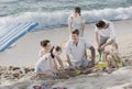 Laughing family playing games on beach on weekend Royalty Free Stock Photo