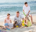 Laughing family playing together on beach Royalty Free Stock Photo