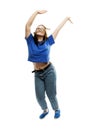 Laughing fat young girl in glasses and jeans emotionally jumps up. Energy and movement. Isolated on a white background. Vertical Royalty Free Stock Photo